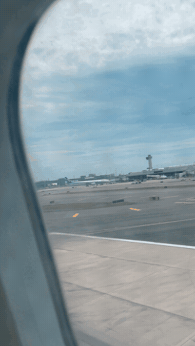 A View Of An Airport Runway From An Airplane GIF