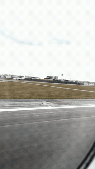 A View Of An Airport Runway From An Airplane GIF