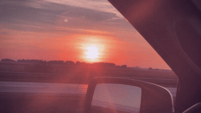 A View Of The Sunset From Inside A Car GIF