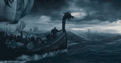 A Viking Ship With A Dragon Head Is Floating On Top Of A Body Of Water . GIF