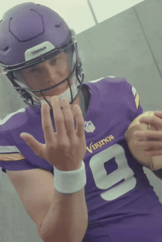 A Vikings Football Player Wearing A Purple Jersey GIF