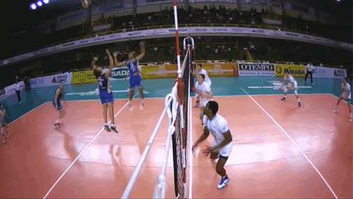 A Volleyball Game Is Being Played In A Stadium With Ads For Mikasa GIF