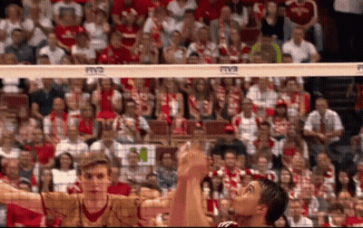 A Volleyball Game Is Being Played In Front Of A Crowd With A Banner That Says Rvc On It GIF