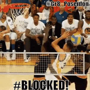 A Volleyball Player Is Blocked By Another Player During A Game Of Basketball GIF