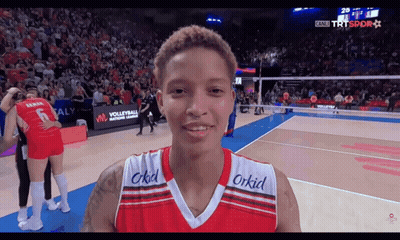 A Volleyball Player Wearing A Red And White Jersey With The Word Orkid On The Front GIF