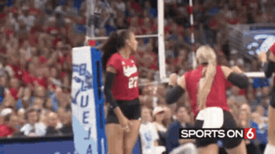 A Volleyball Player Wearing A Red Jersey With The Number 27 On It GIF