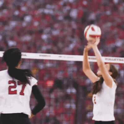 A Volleyball Player With The Number 27 On Her Jersey Is Getting Ready To Serve The Ball GIF