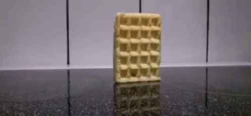 A Waffle Bar Is Sitting On A Black Counter . GIF