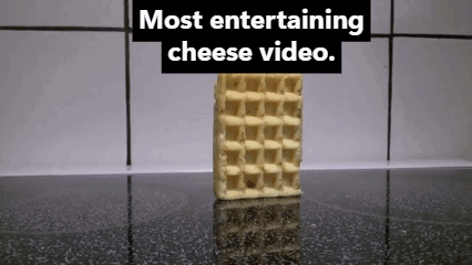 A Waffle With A Bite Taken Out Of It And The Words Most Entertaining Cheese Video Behind It GIF