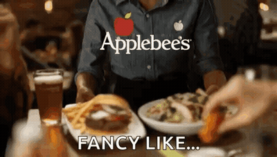 A Waitress At Applebee 'S Is Serving A Hamburger And French Fries GIF