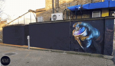 A Wall With A Painting Of A Hand Holding A Spray Can With The Word Energy Written On It GIF