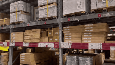 A Warehouse Filled With Lots Of Boxes Including One That Says ' Ikea ' GIF