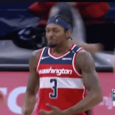 A Washington Wizards Basketball Player Is Standing On The Court During A Game . GIF