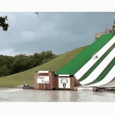 A Water Slide With A Sign That Says " Royal Flush " GIF