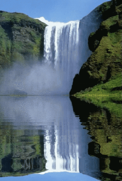 A Waterfall Is Reflected In A Lake Surrounded By Mountains GIF