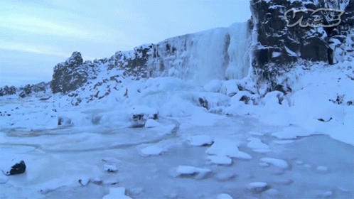 A Waterfall Is Surrounded By Snow And Ice With A Watermark That Says Cnn GIF