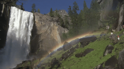 A Waterfall With A Rainbow Behind It GIF