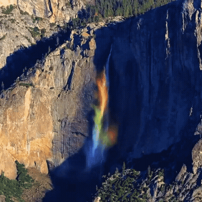 A Waterfall With A Rainbow In The Middle GIF