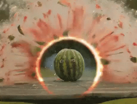 A Watermelon Is Exploding On A Table With A Red Circle Around It . GIF