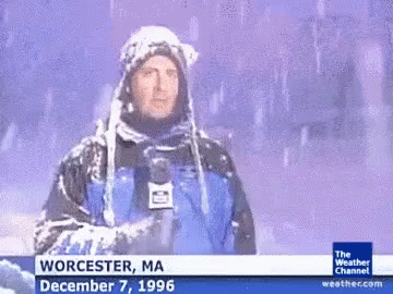 A Weatherman From Worcester Ma Is Standing In The Snow Holding A Microphone GIF