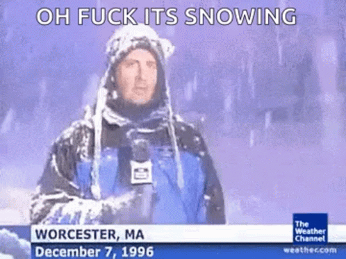 A Weatherman Is Standing In The Snow Holding A Microphone GIF