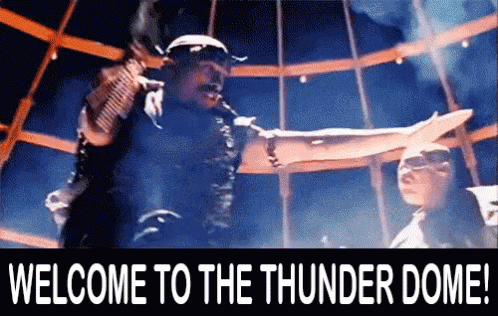 A Welcome To The Thunder Dome Sign With A Man In The Background GIF