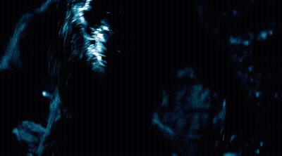 A Werewolf With Its Mouth Open In The Dark GIF