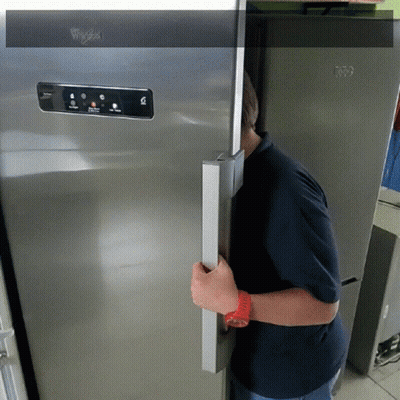 A Whirlpool Refrigerator Is Being Opened By A Man GIF