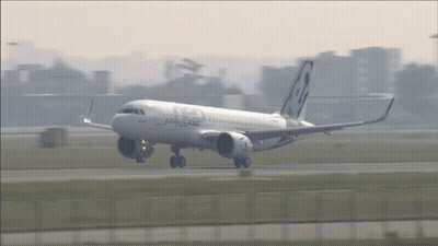 A White Airbus A320 Is Taking Off From An Airport GIF