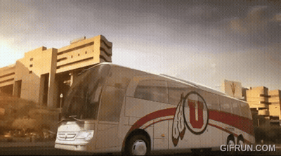 A White And Red Bus With The Letter U On The Side GIF