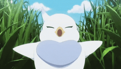 A White Bird With A Heart Shaped Mouth Is Standing In A Field Of Grass GIF
