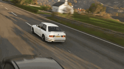 A White Bmw Is Driving Down A Road With A Yellow License Plate That Says ' Aoc ' On It GIF