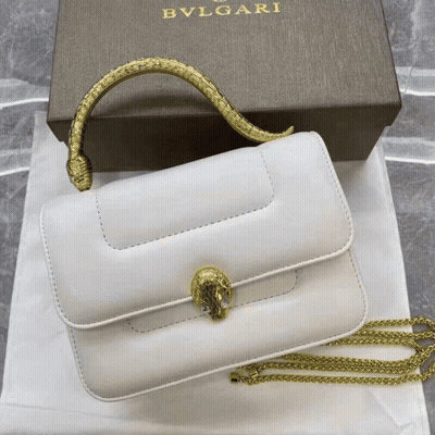 A White Bvlgari Purse With A Gold Handle GIF