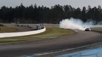 A White Car Is Drifting On A Race Track GIF