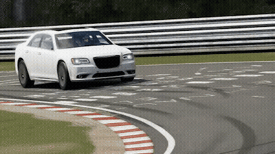 A White Car Is Driving Around A Curve On A Race Track GIF