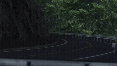 A White Car Is Driving Down A Curvy Road With Trees On The Side GIF
