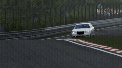 A White Car Is Driving Down A Race Track With A Red White And Blue Stripe On The Side GIF