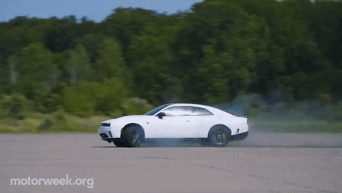 A White Car Is Driving Down A Road With Motorweek.org Written On The Bottom Right GIF