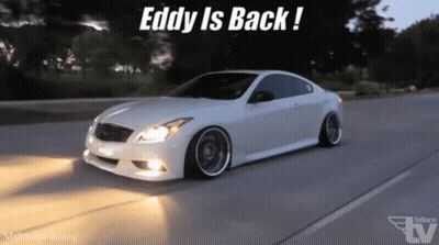 A White Car Is Driving Down A Road With The Words " Eddy Is Back " On The Bottom GIF