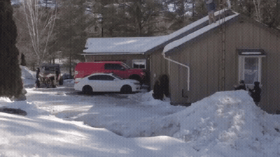 A White Car Is Parked In Front Of A Brown House GIF