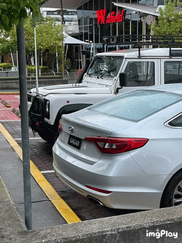 A White Car With A License Plate That Says Gagan Is Parked In A Parking Lot GIF
