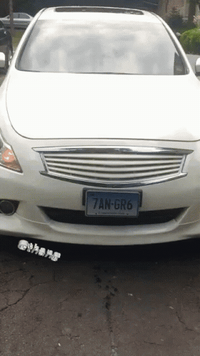 A White Car With The License Plate 7An-Gr6 GIF