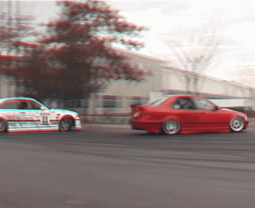 A White Car With The Number 11 On It Is Driving Next To A Red Car GIF