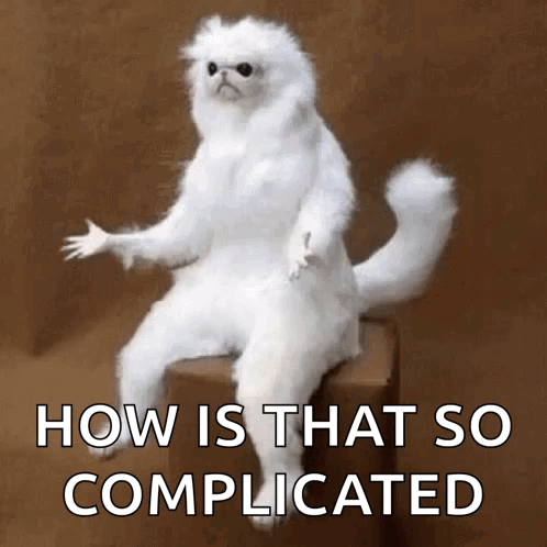 A White Cat Is Sitting On A Box With The Words How Is That So Complicated Above It GIF