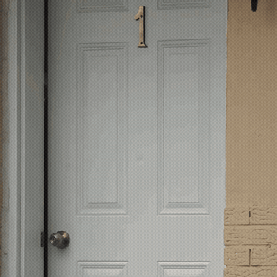 A White Door With A Number 1 On It GIF
