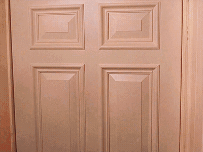 A White Door With Four Squares On It Is Open To A Dark Room GIF