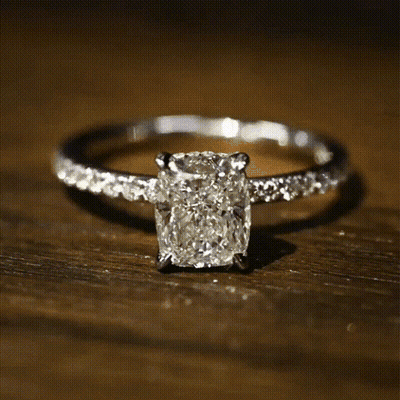 A White Gold Ring With A Square Diamond In The Center GIF