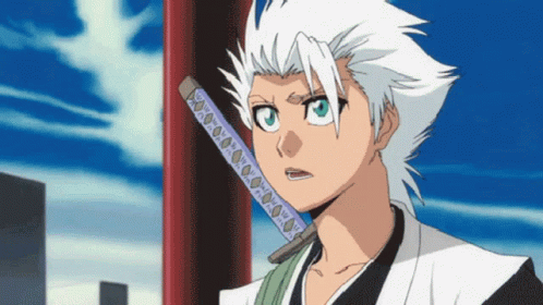 A White Haired Anime Character Holding A Sword In His Mouth GIF