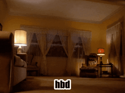 A White Horse Is Standing In A Living Room With A Hbd Sticker GIF
