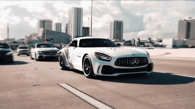 A White Mercedes Is Driving Down A Highway Next To Other Cars GIF
